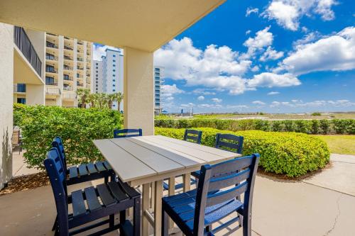 a table and chairs with a view of the ocean at Phoenix VII 7015 condo in Orange Beach
