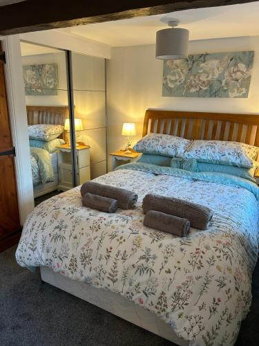a bedroom with a bed with two pillows on it at 1 Bed cottage town centre free private parking cycle store Boroughbridge in Boroughbridge