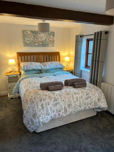 a bedroom with a large bed with two pillows at 1 Bed cottage town centre free private parking cycle store Boroughbridge in Boroughbridge