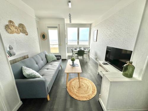 un salon avec un canapé et une table dans l'établissement Sea View and balcony with 2 bedrooms in Berck-Plage, à Berck-sur-Mer