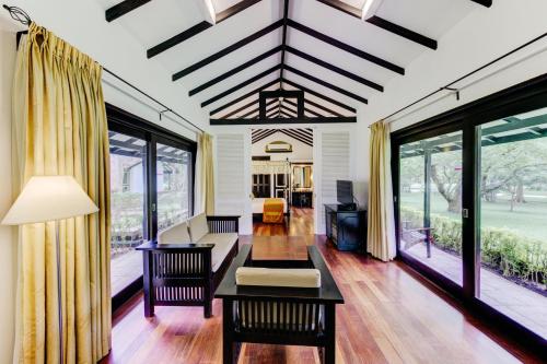 a living room with a couch and a table at Cinnamon Lodge Habarana in Sigiriya