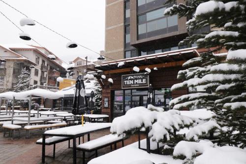 a group of benches covered in snow in front of a building at MP613H Mountain Plaza Hotel Room Hotel Room in Copper Mountain