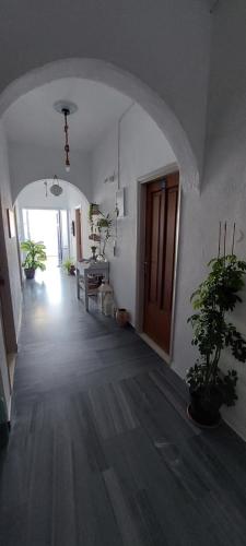 an empty hallway with an archway in a house at Kalliopis Rooms in Katapola