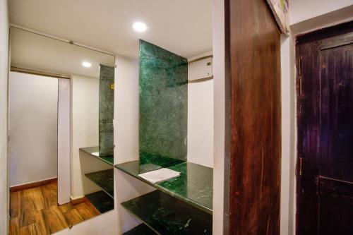 a room with a green glass wall at Lemonmint Svelton Manor in Calangute