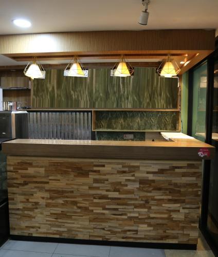 a bar in a restaurant with three lights at Xpeed Holiday Hotel in Kuala Lumpur