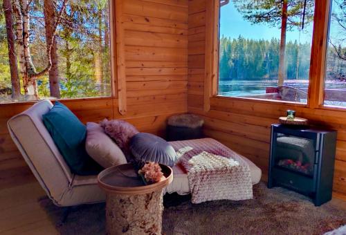a room with a couch and a stove and a window at Nature Dream Days in Muhos
