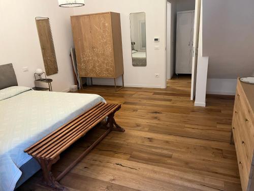 a bedroom with a bed and a wooden floor at Bb7 house in Trieste