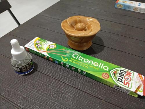 a box of cereal and a miniature doughnut on a table at Ancient Breeze HomeStay in Anuradhapura