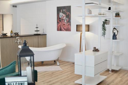 a bathroom with a white tub in a room at Garden Luxus Apartment in Bayreuth