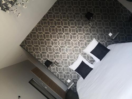 an overhead view of a bedroom with a bed with pillows at La maison de Bruno in Juliénas