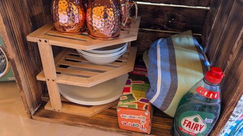 a wooden shelf with some pots and pans on it at Camping Solau in Espot