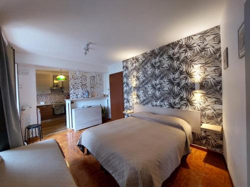 a bedroom with a bed and a wall at Al Teatro Antico Rooms & House in Taormina