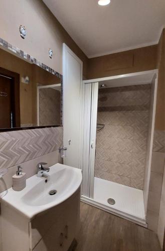 a bathroom with a sink and a shower at Al Teatro Antico Rooms & House in Taormina