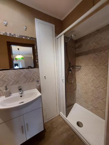 a bathroom with a sink and a shower at Al Teatro Antico Rooms & House in Taormina