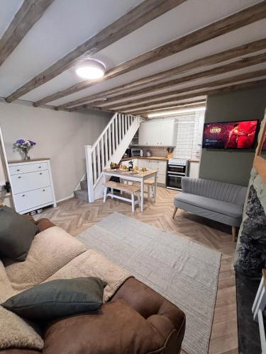 a living room with a couch and a table at The Cottage on the Rock in Barmouth