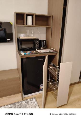 a small kitchen with a microwave and a dishwasher at غرف سنجل سكن العاصمة in Kafr ash Sharā‘inah