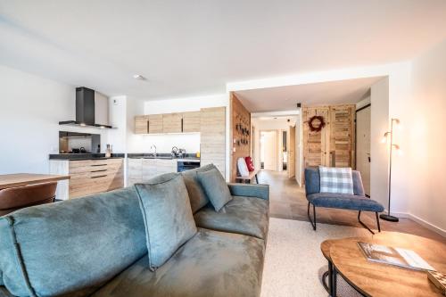 a living room with a couch and a kitchen at Apartment Montami, Châtel - by EMERALD STAY in Châtel
