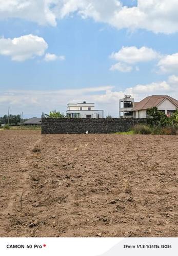 a fence in a field with houses in the background at Blessed Home, Nakuru in Lanet