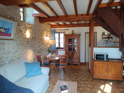 un salon avec un canapé et une table dans l'établissement Le Bray, à Colleville-sur-Mer