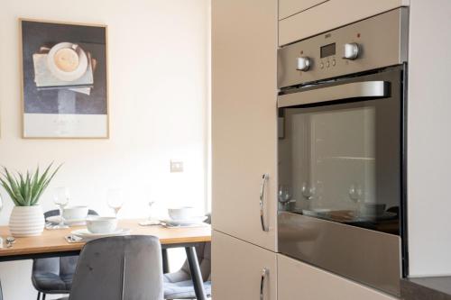 a kitchen with a table and a oven at Bartonshill House in Glasgow