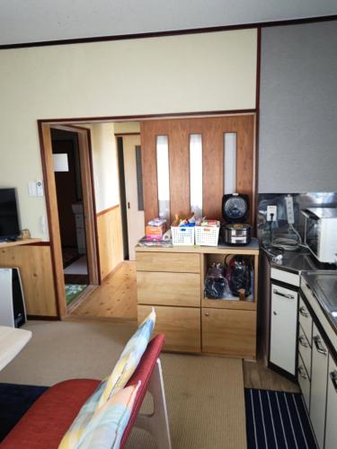 a kitchen with a stove and a counter top at Hermit 知床 in Shari