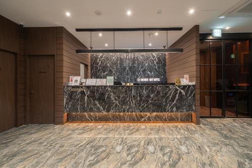 a lobby with a marble counter in a building at Incheon BrownDot Hotel Guwol in Incheon