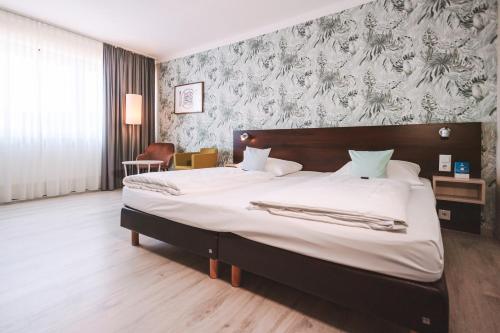 Postel nebo postele na pokoji v ubytování Best Western Hotel Ambassador