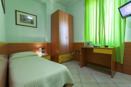 a bedroom with a bed and a television in it at Hotel La Quercia in Mozzo