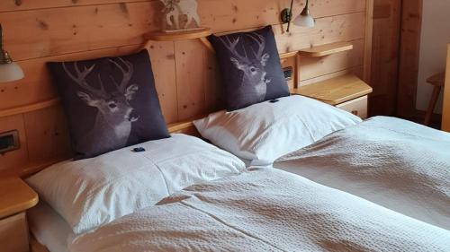 a bedroom with a bed with two deer heads on it at Garni Cir in Santa Cristina in Val Gardena