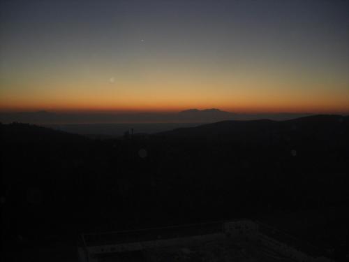 a view of the sunset from the top of a building at Evmorfes Villas in Poligiros