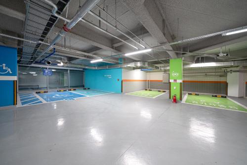 an empty parking lot with blue and green mats at DIAMER Hotel Sokcho by AankStay in Yangyang
