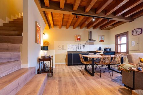 a living room and kitchen with a table and chairs at Casina de Santa Ana II By Silastur in Siero