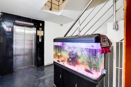 a large fish tank sitting in a room at Kings Court Hotel Pitampura in New Delhi