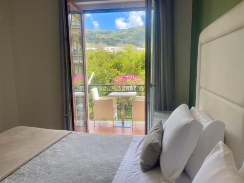 a bedroom with a bed with a view of a balcony at Bougainvillea Relais in Sorrento