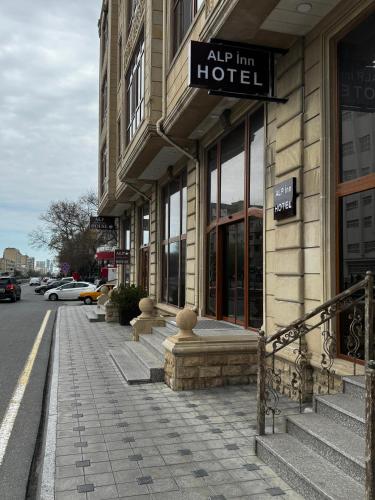 a building with a hotel sign on the side of a street at Alp Inn Hotel in Baku