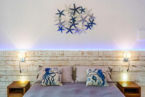 a bedroom with a bed with two night stands and two lamps at La Rocca Maison de Charme in Moneglia