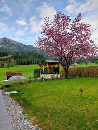 a park with a tree and a gazebo at Hofpower`s Mountain Feeling in Hinterstoder