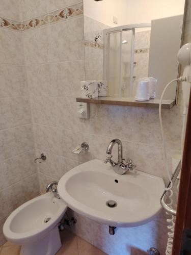 a bathroom with a white sink and a mirror at Hotel Silvia Framura - Cinque Terre in Framura