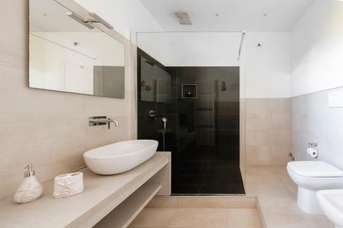 a bathroom with a sink and a toilet and a shower at Case Vacanze Otranto in Otranto
