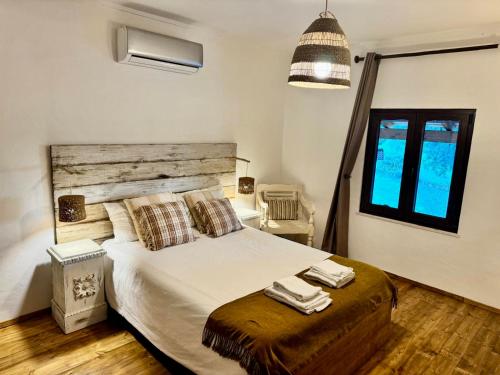 a bedroom with a bed with two towels on it at Montado Village in Portel
