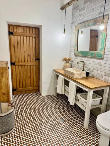 a bathroom with a wooden sink and a toilet at Montado Village in Portel