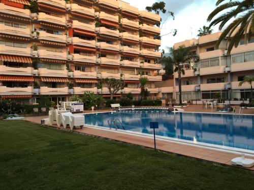 a large apartment building with a large swimming pool at Jose Carlos in Puerto de la Cruz