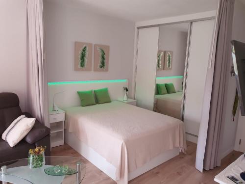 a white bedroom with a bed and a mirror at Jose Carlos in Puerto de la Cruz