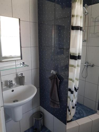 a bathroom with a sink and a shower at Pokoje gościnne u Laury in Rewal