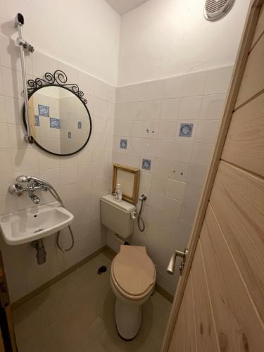 a small bathroom with a toilet and a sink at Bonne Chance Apartment Sozopol in Sozopol