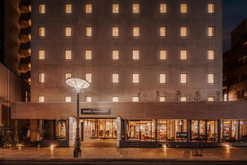 a facade of a building with lights on at OMO3 Tokyo Akasaka by Hoshino Resort in Tokyo
