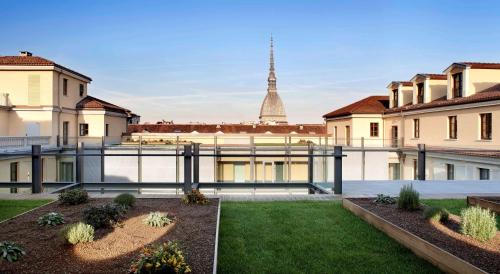 a courtyard with a view of the eiffel tower at NH Collection Torino Piazza Carlina in Turin