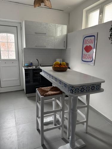 a kitchen with a table with a bowl of fruit on it at Casa Azul in Kokkari
