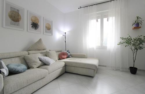 a baby sleeping on a couch in a living room at Forli con Park view style e comfort in Forlì