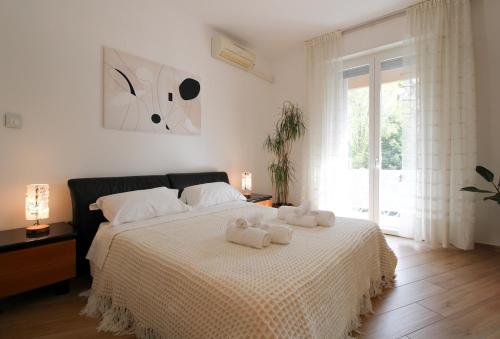 a bedroom with a bed with two towels on it at Forli con Park view style e comfort in Forlì